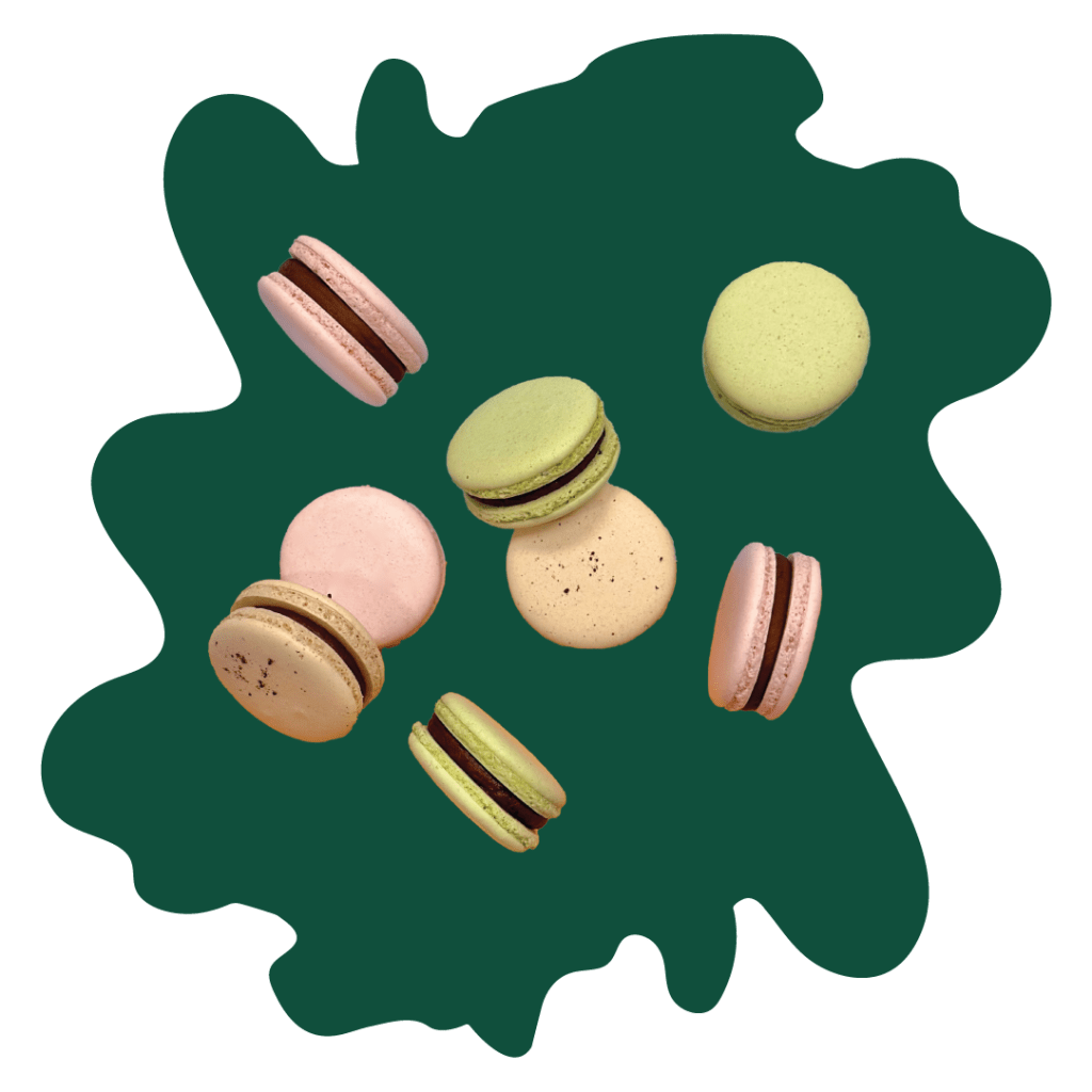 A graphic of a green blob background with a cut-out photo of macarons from Table Bloom.